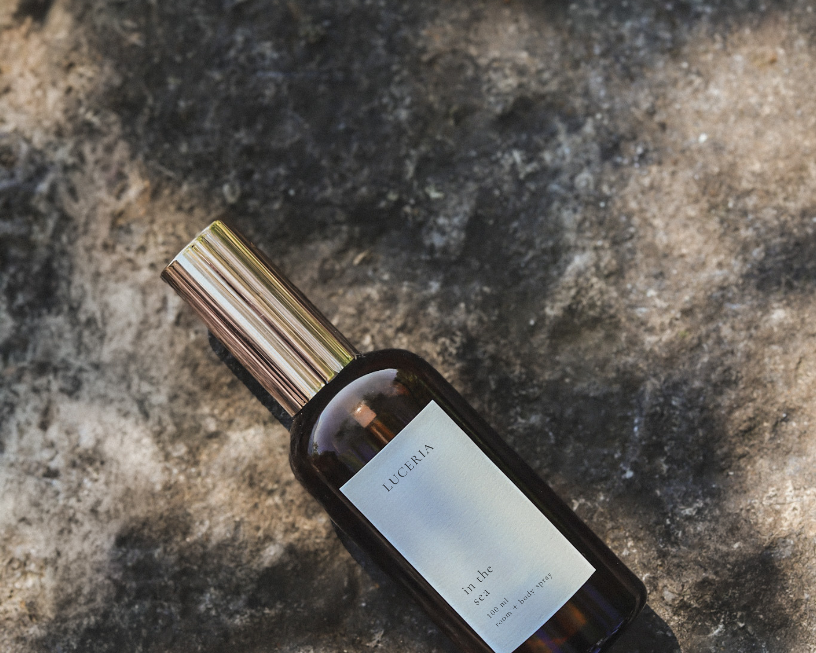 Brown bottle with gold cap on a beige background