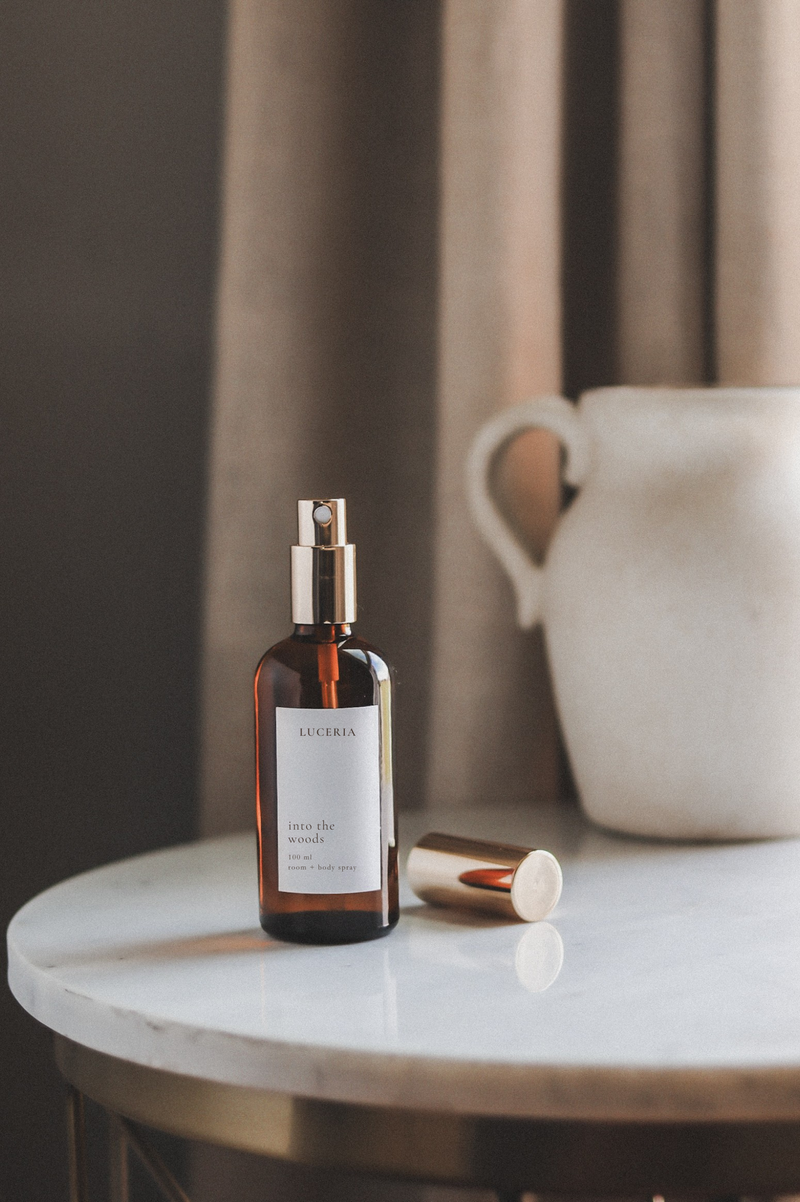 Brown bottle with dropper on a marble surface with a neutral background