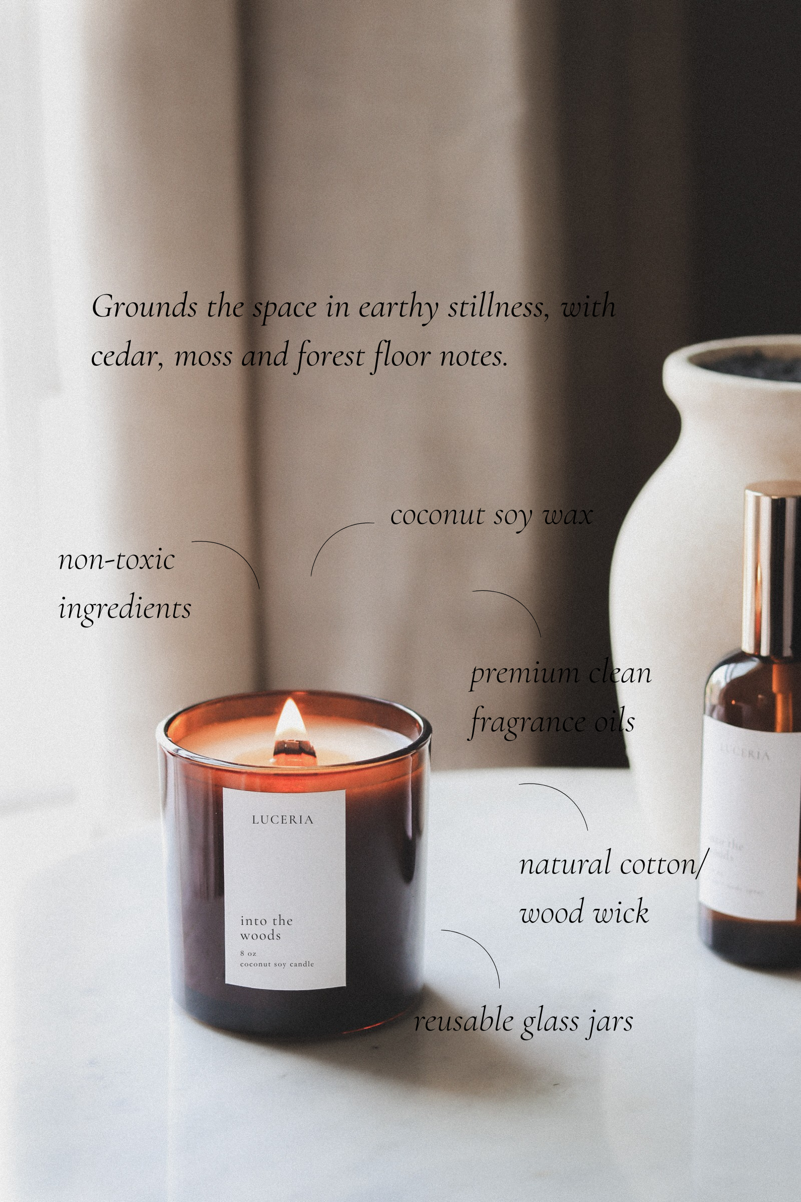 Amber glass candle called Into the Woods from Luceria Candle co. on a marble table with textured vase.