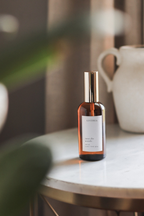 Small bottle with a label on a marble surface with a blurred background