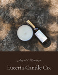 Candle and bottle on a textured surface with 'Luceria Candle Co.' branding.