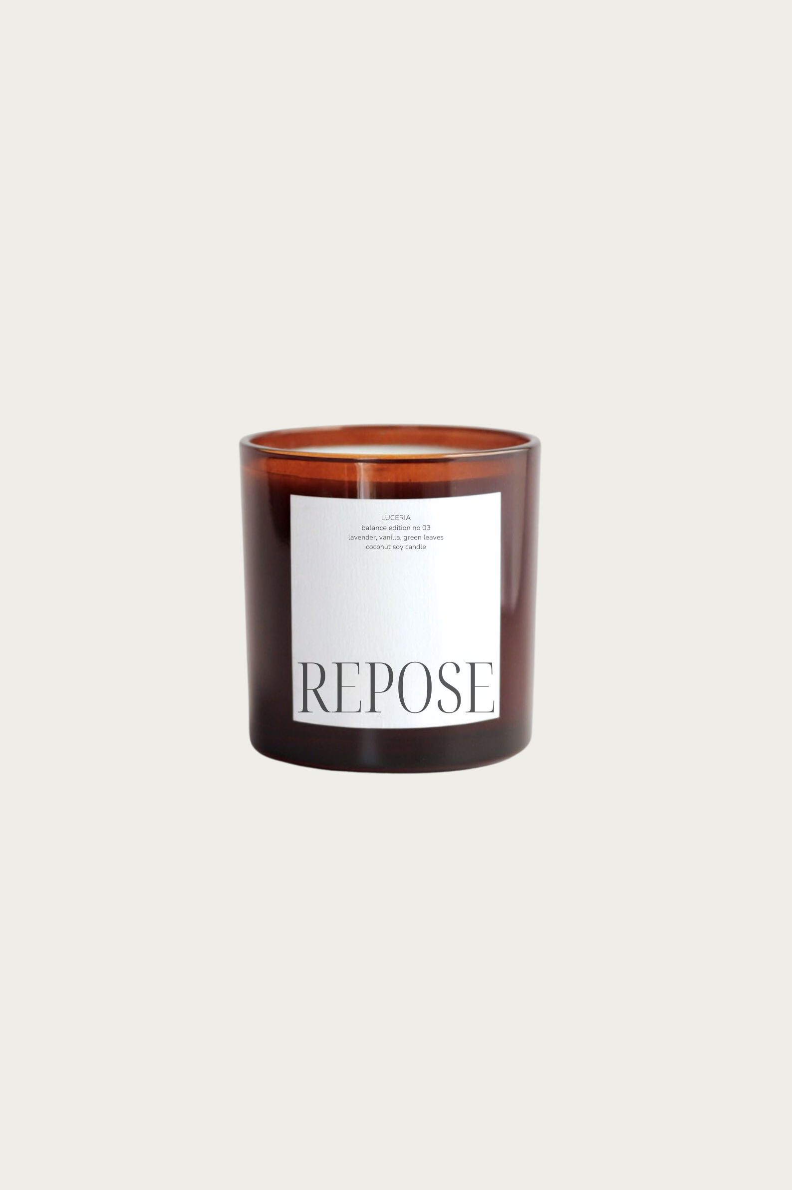 Lavender vanilla scented candle with 'Repose' label on a beige background