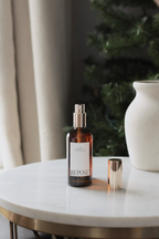 Bottle labeled 'Repose' on a marble surface with a neutral background