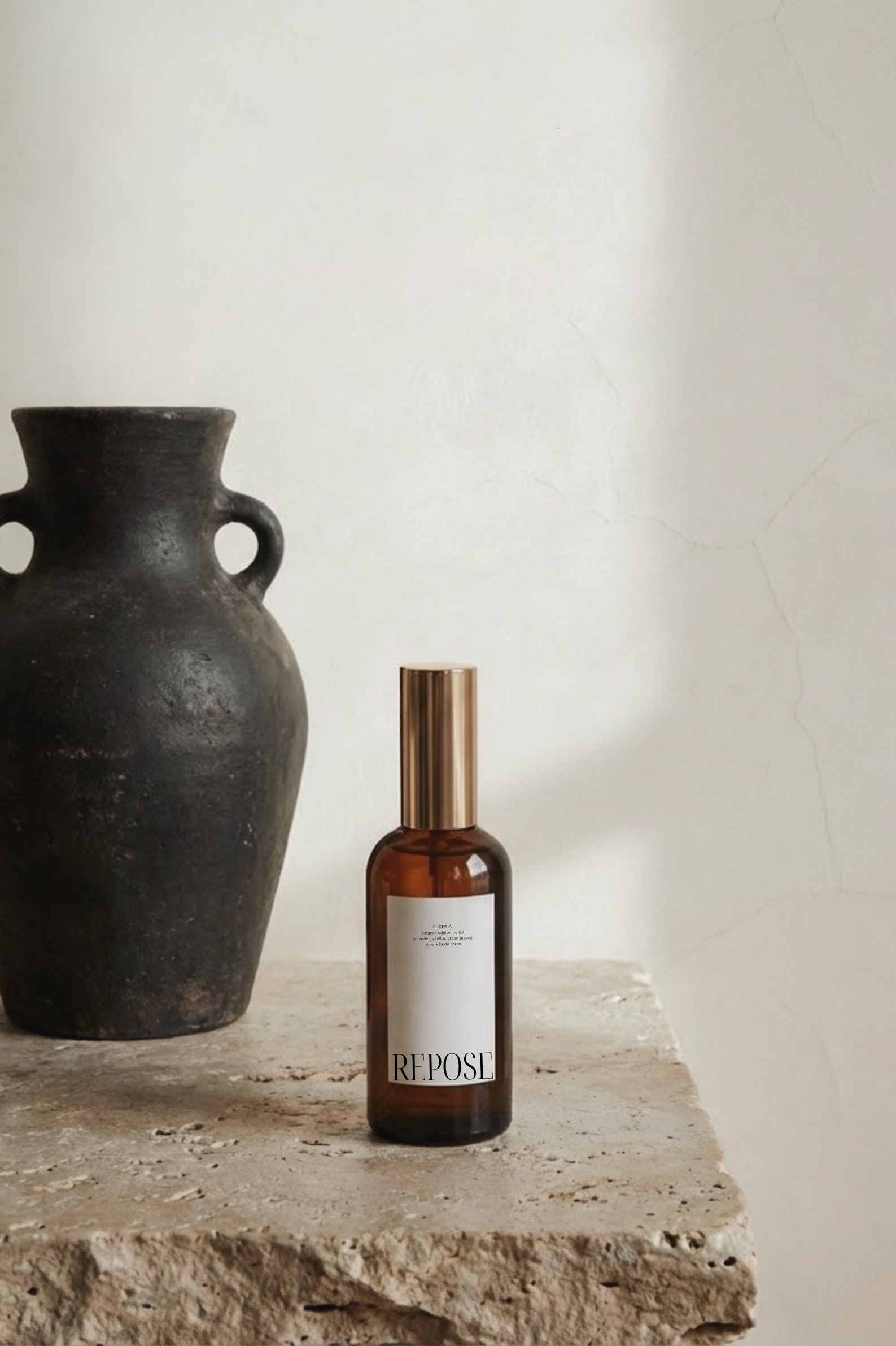 Brown bottle labeled 'REPOST' on a stone surface with a black vase in the background