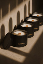 A row of black candles with luceria branding in a sunset neutral background