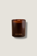 Brown amber candle with 'LUCERIA' branding on a light gray background