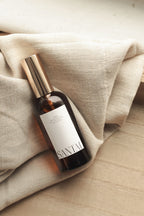 Bottle of SANTAL oil on a beige fabric background