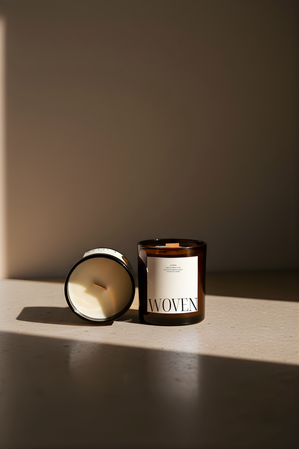 Luceria No. 01 Woven coconut soy candle in an amber glass jar with a crackling wood wick styled in soft natural light.